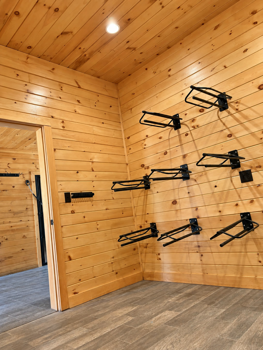 Built-in wood cubbies and cabinets in a barn tack room