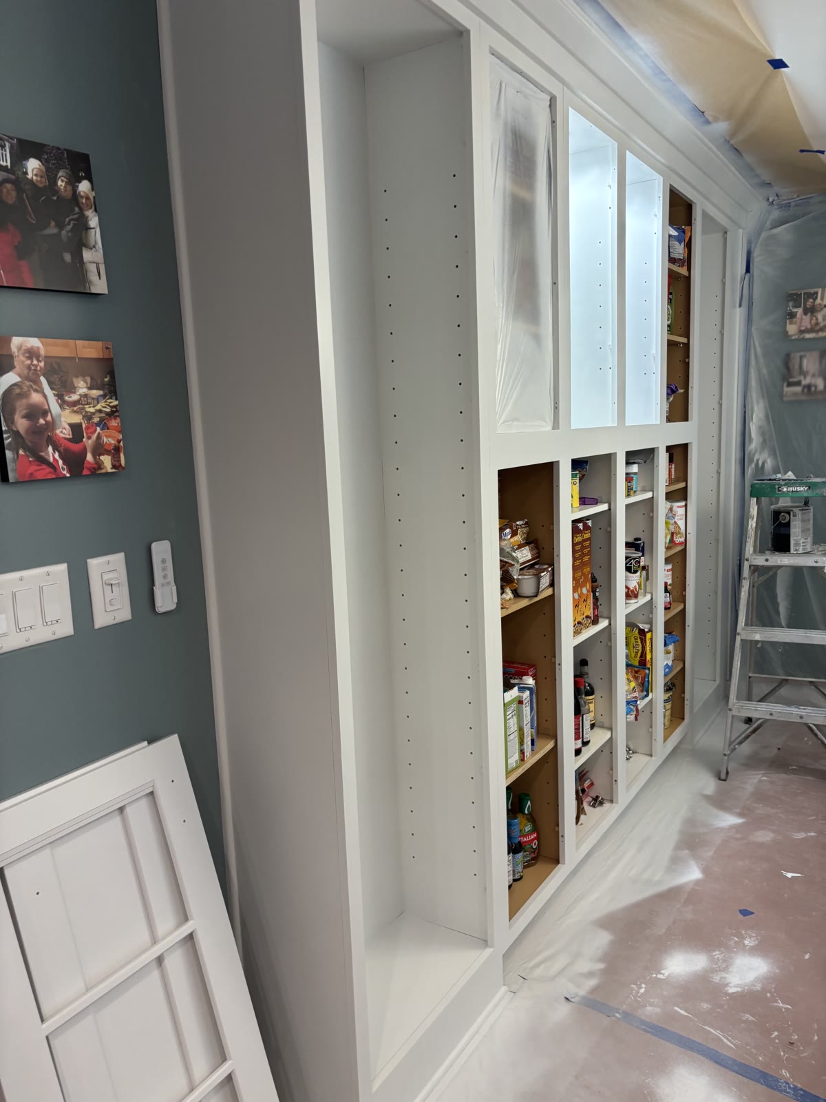 Built-in pantry cabinet masked and under construction
