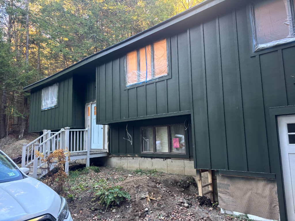 Residential exterior with board-and-batten siding and protected windows