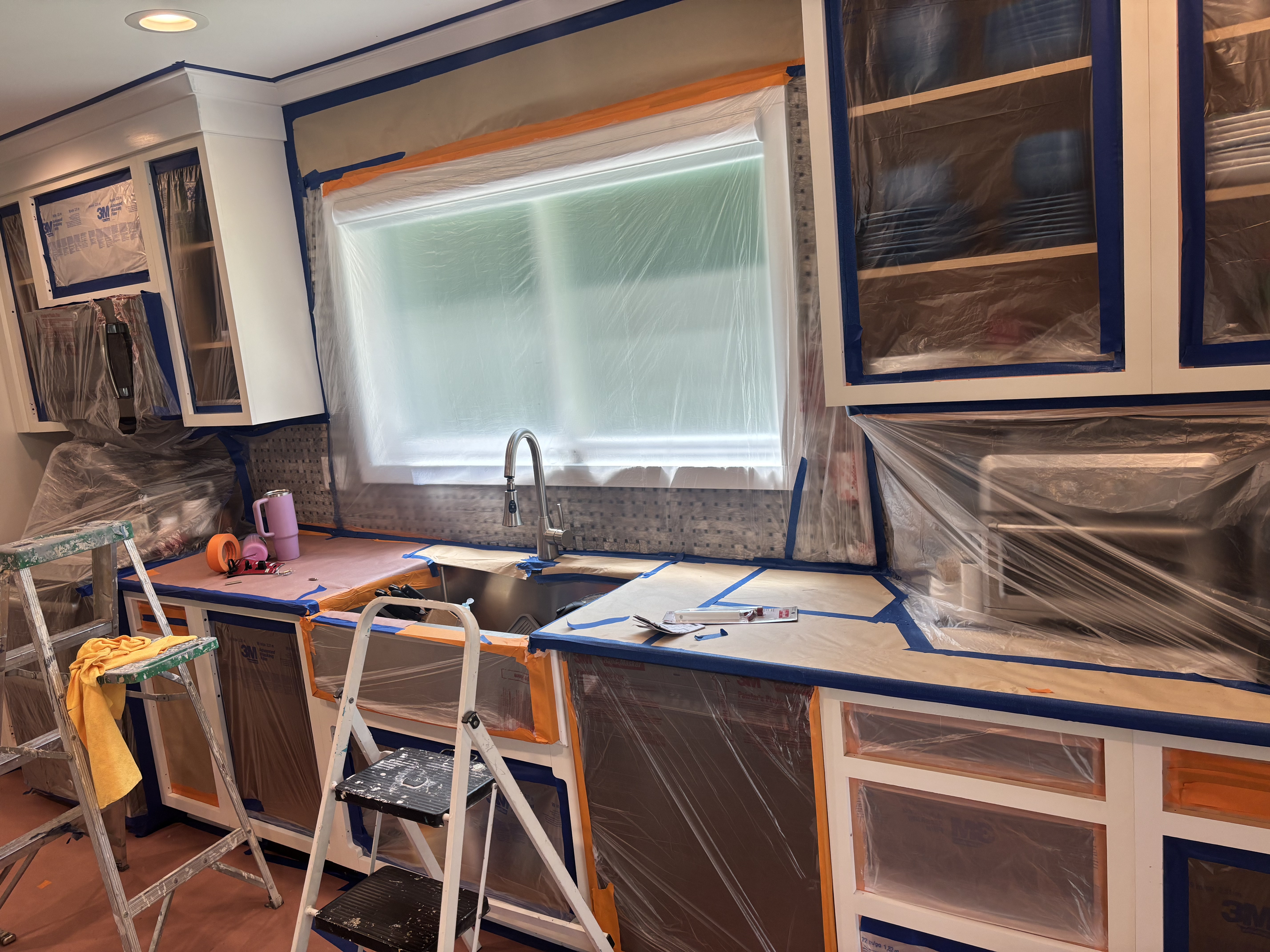 Kitchen masked and protected during cabinet painting